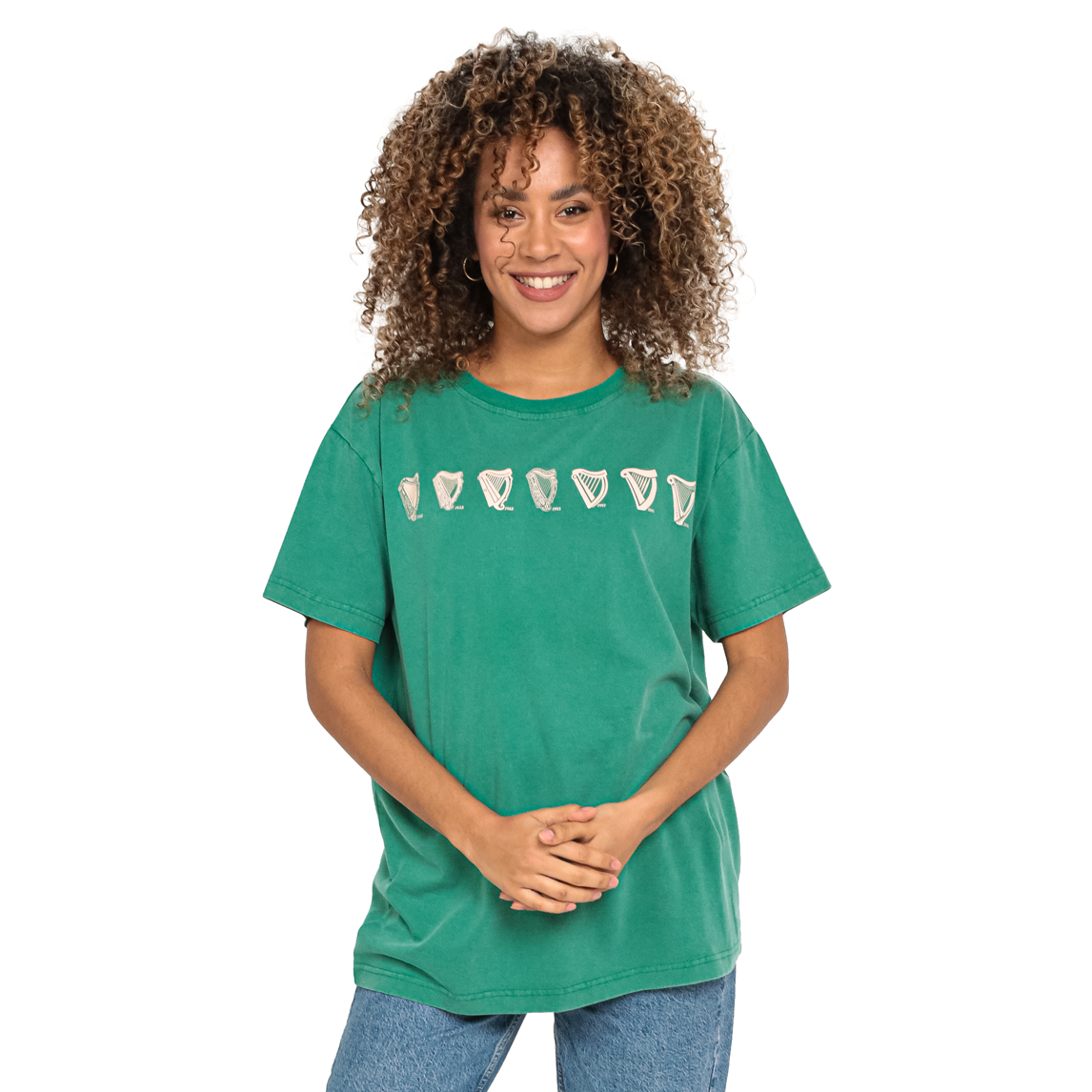 A woman wearing a Guinness Evolution Harp Green Tee showcasing the Guinness Evolution of the Harp design.